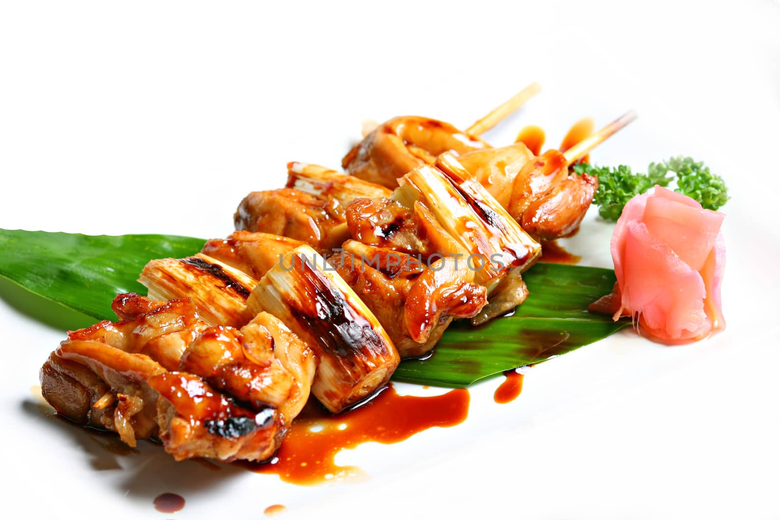 Charcoal grilled chicken Yakitori with tare sauce. Japanese food style in white background by Mercedess