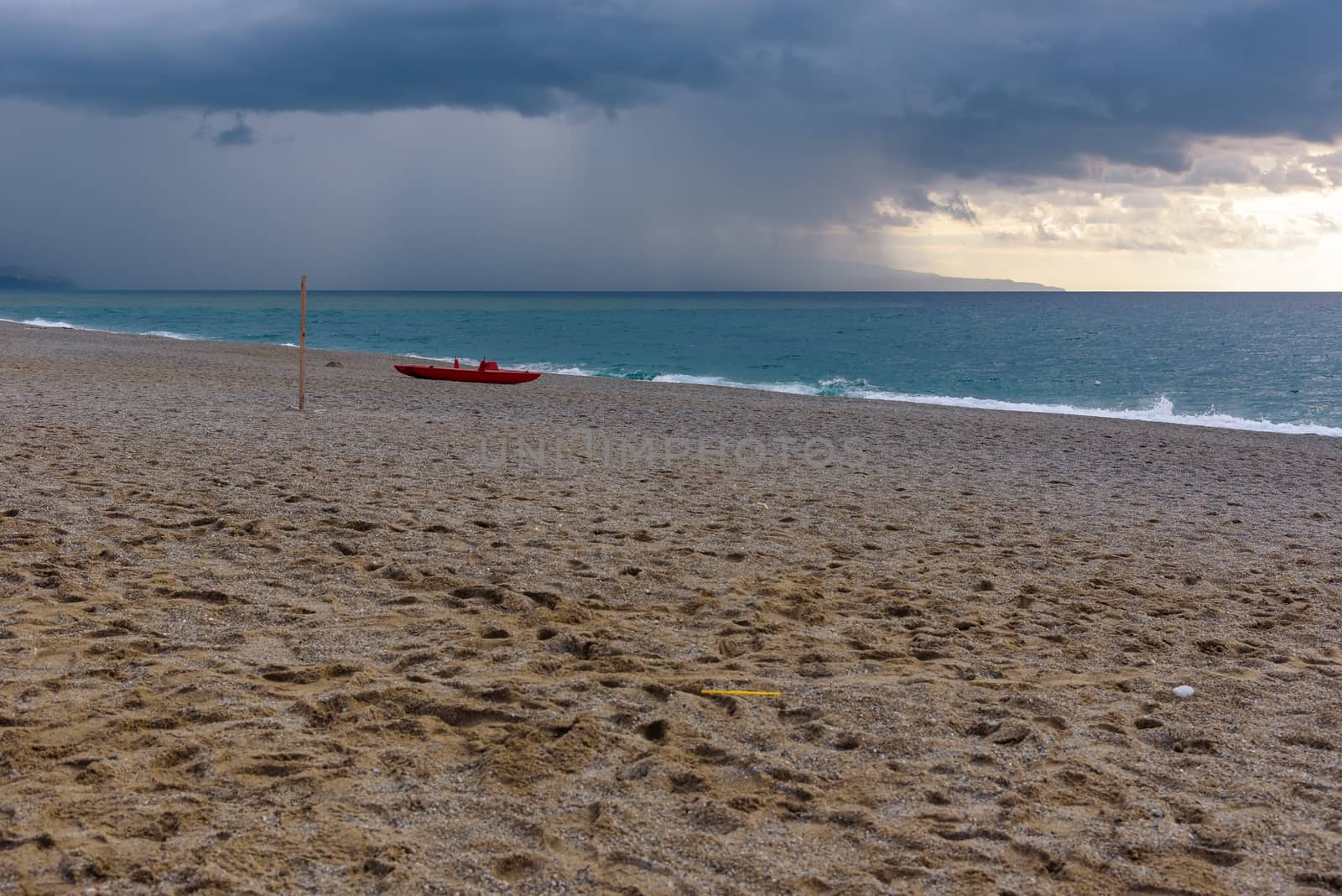 Dark clouds over the calabrian beach by mkos83