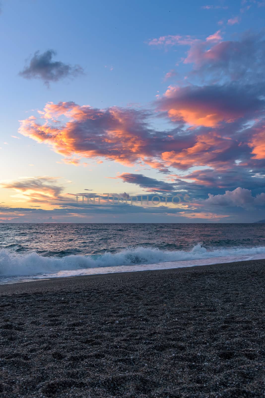 Vertical view of sunset on the Calabrian beach by mkos83