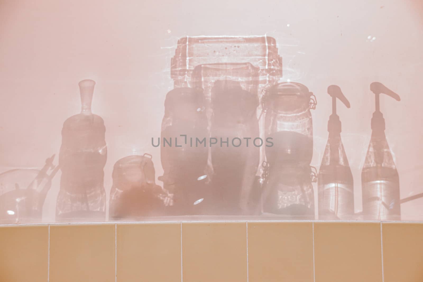Conceptual photo showing the silhouettes of glass bottle containers to show concept of sanitation, infection control and good hygiene to fight the spread of covid-19 pandemic
