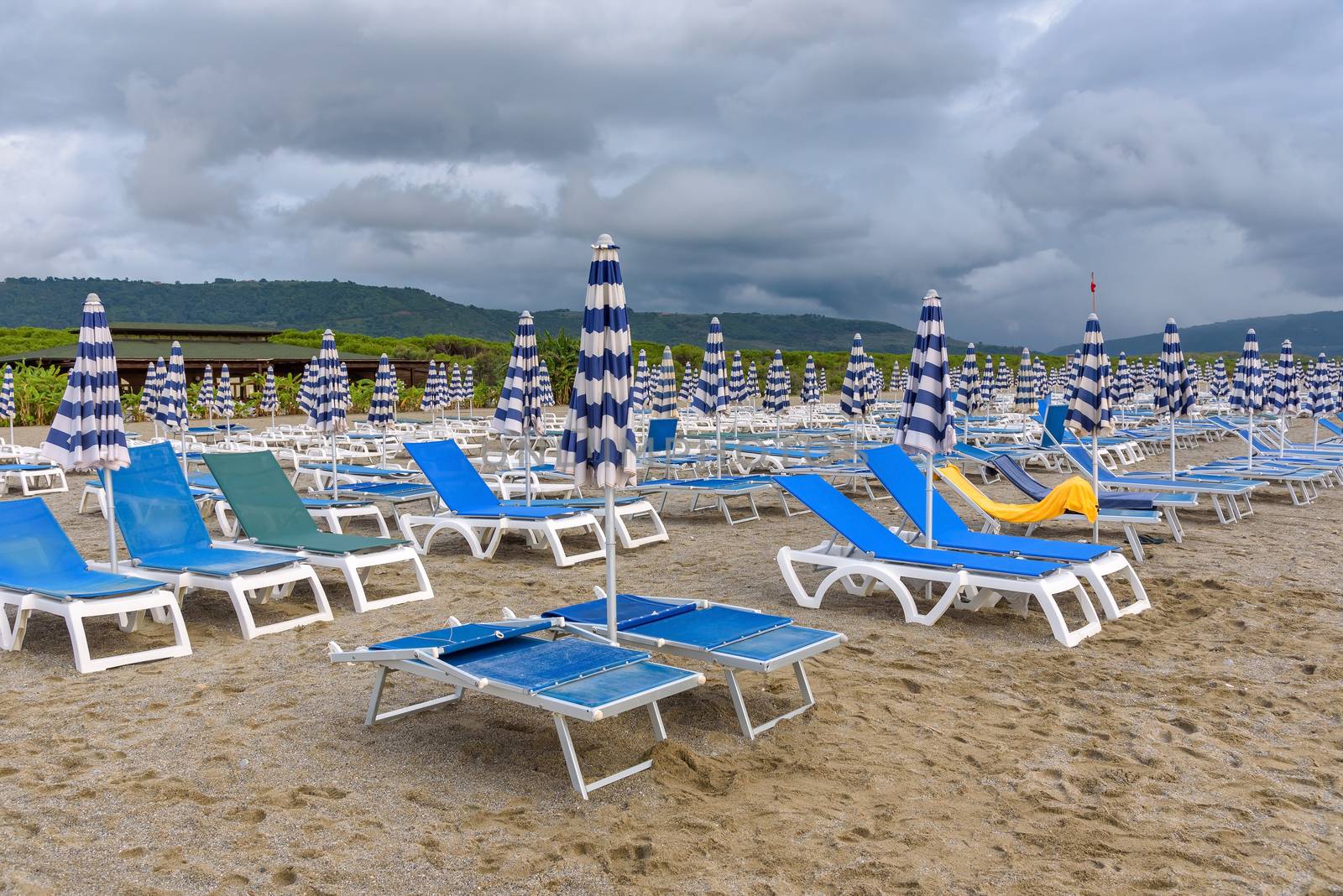 Sunbeds and umbrellas on the calabrian beach by mkos83