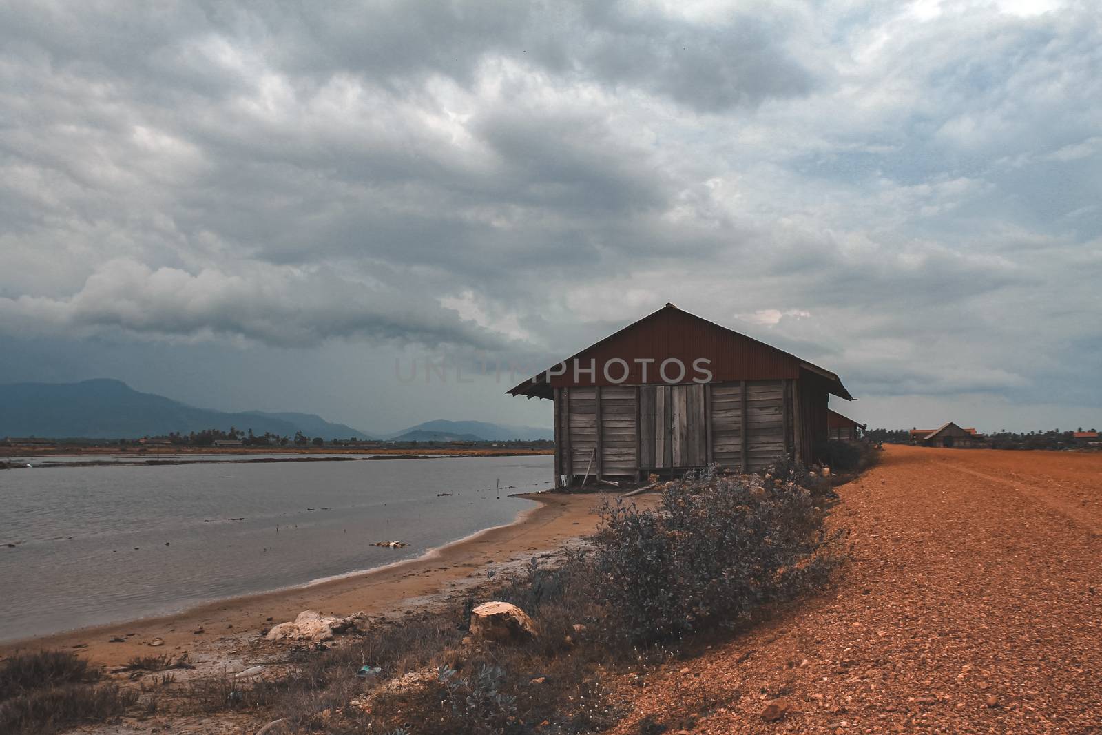Cinematic photo of an abandoned salt storage house in the famous salt fields of Kampot, shows the effect of covid-19 lock downs on the local industry, economy and livelihood of the Cambodian people