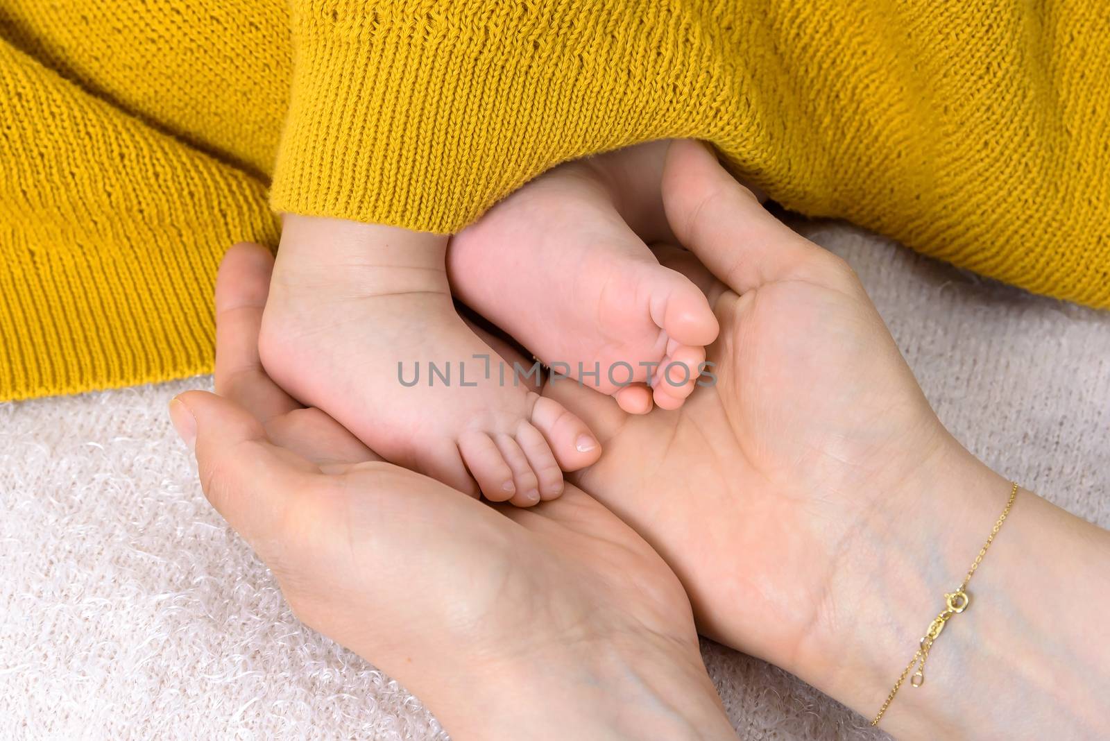 Closeup of newborn baby feet in parent hands