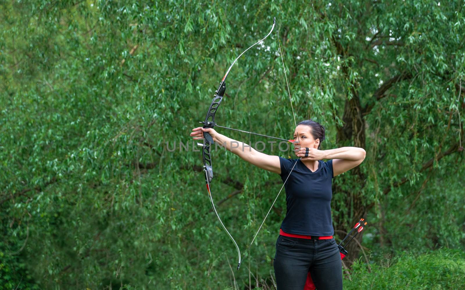 arrow shooting from a bow in nature, sport archery. copy space by Edophoto