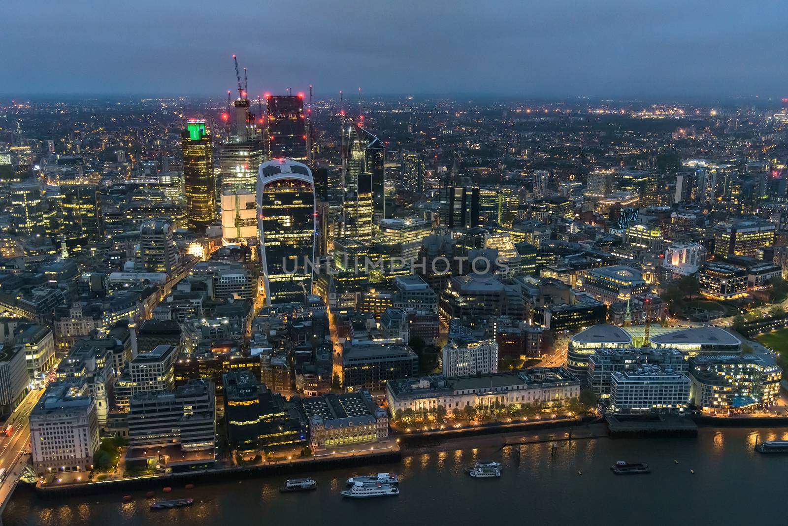 Aerial view of City of London at night on a cloudy day