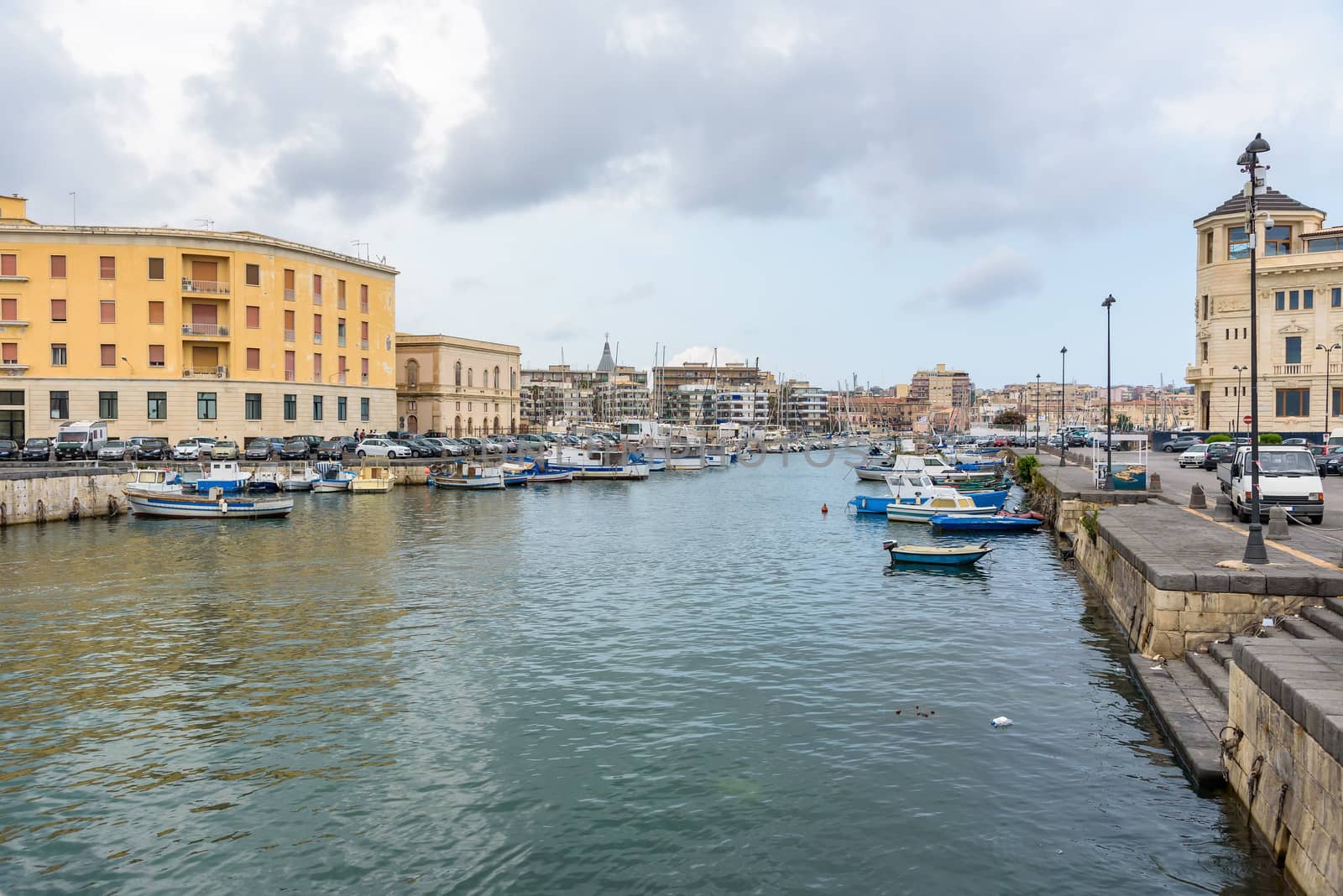 Boats moored in small sea port in Syracuse, Sicily, Italy