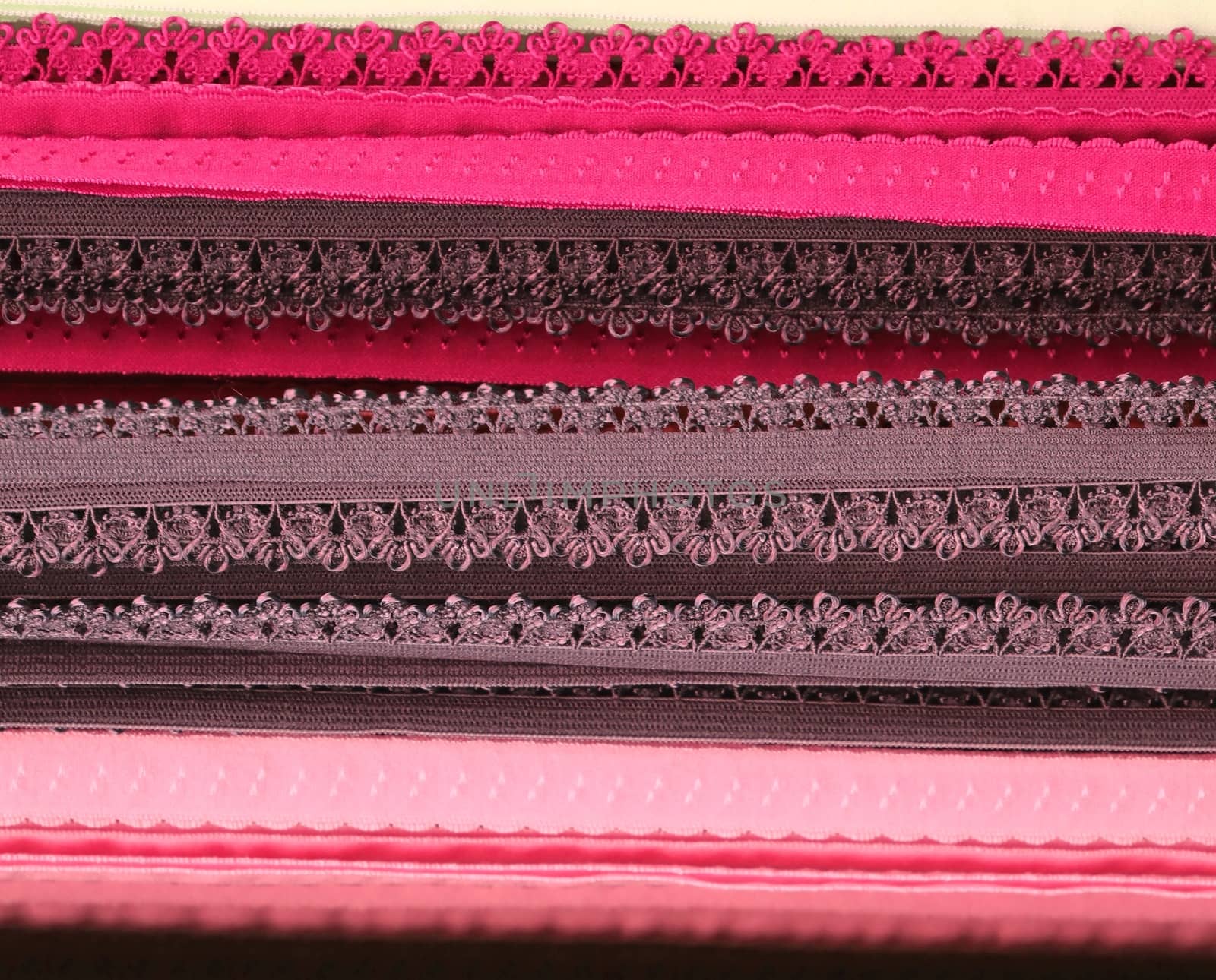 Detailed close up view on samples of cloth and fabrics in different colors found at a fabrics market.