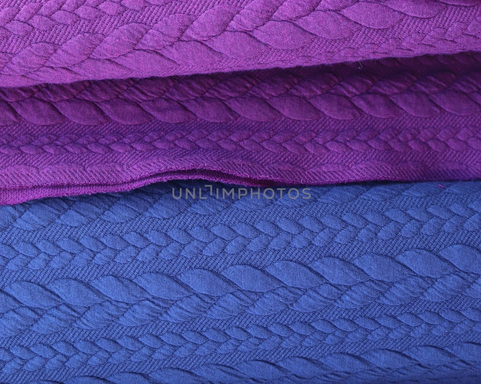 Detailed close up view on samples of cloth and fabrics in different colors found at a fabrics market.