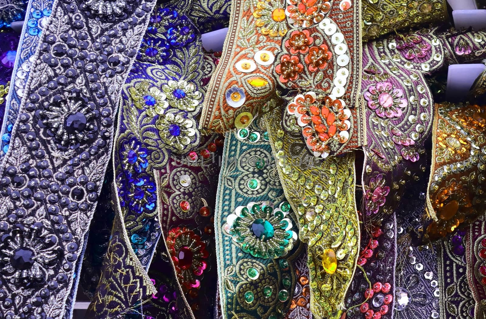 Detailed close up view on samples of cloth and fabrics in different colors found at a fabrics market.