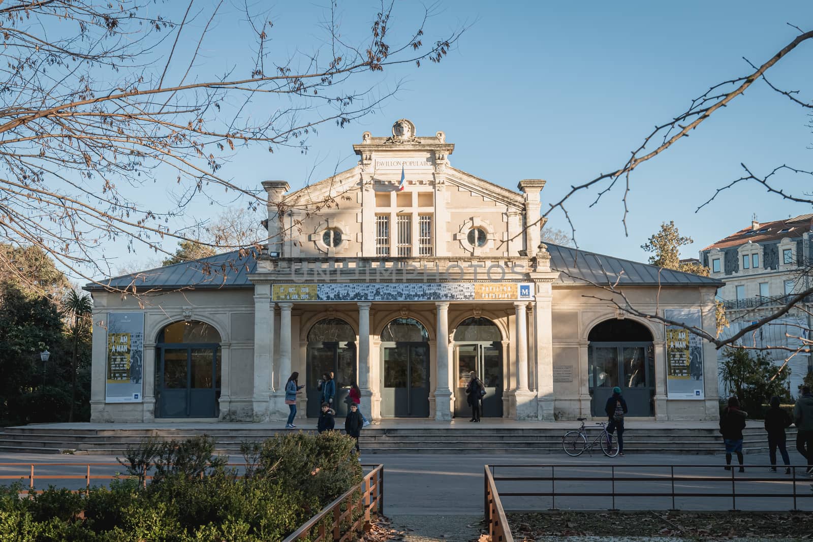 Montpellier, France - January 2, 2019: architectural detail of the popular pavilion (Pavillon Populaire) next to the Place de la Comedie where people pass on a winter day