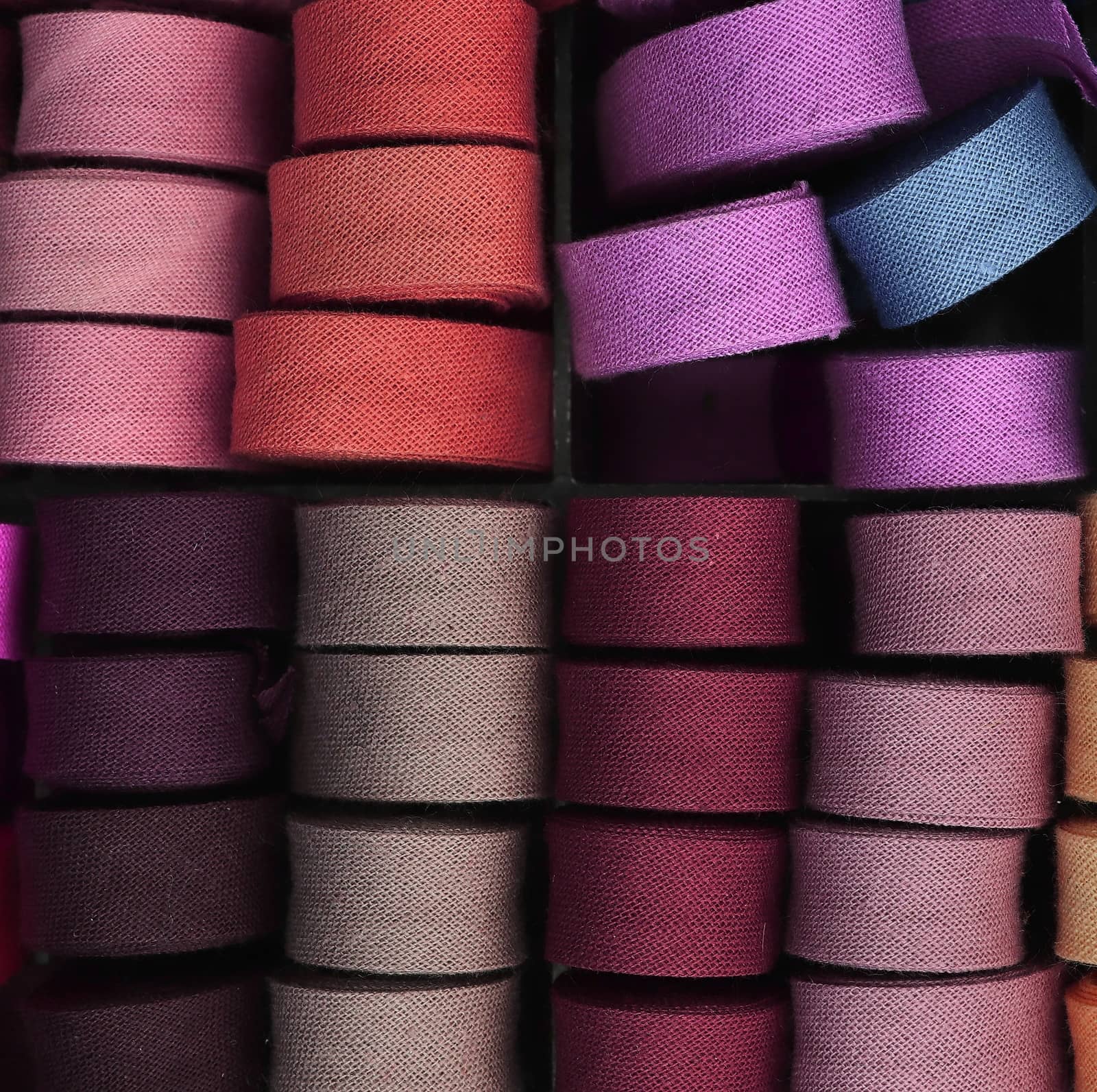 Detailed close up view on samples of cloth and fabrics in different colors found at a fabrics market.