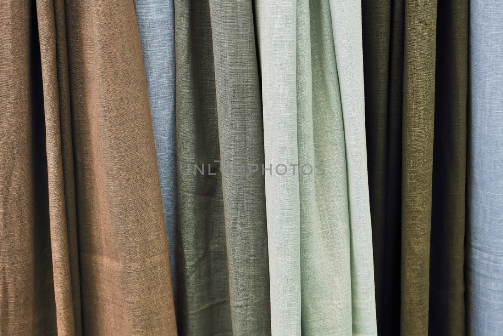 Detailed close up view on samples of cloth and fabrics in different colors found at a fabrics market.