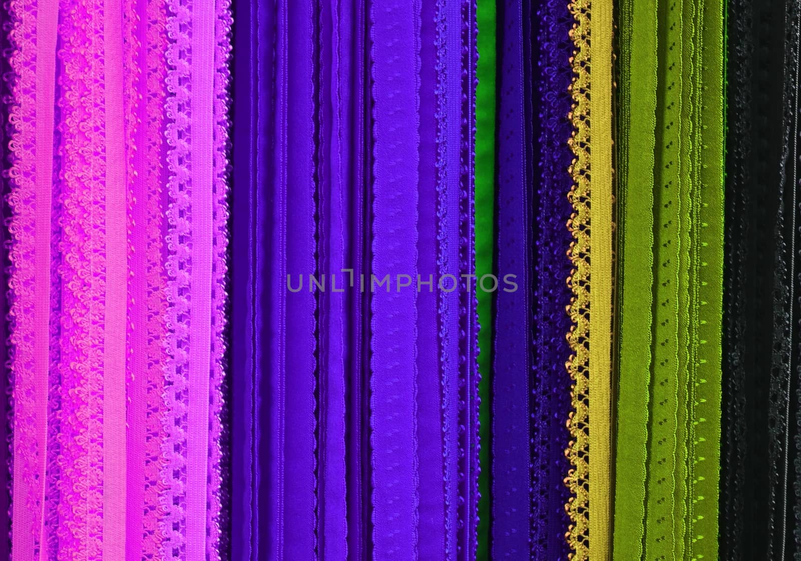 Detailed close up view on samples of cloth and fabrics in different colors found at a fabrics market.