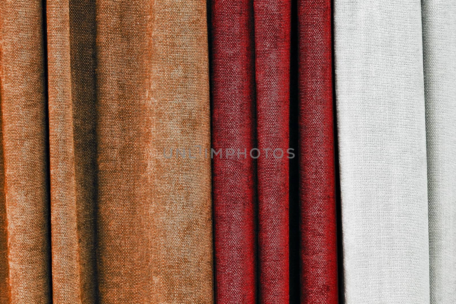 Detailed close up view on samples of cloth and fabrics in different colors found at a fabrics market.