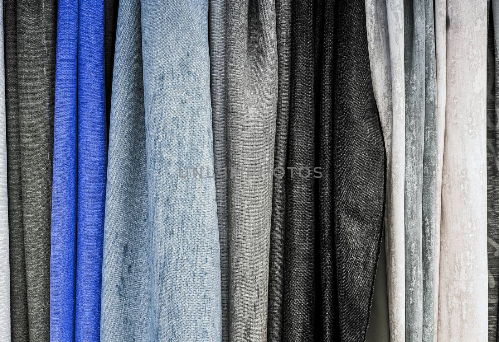 Detailed close up view on samples of cloth and fabrics in different colors found at a fabrics market.