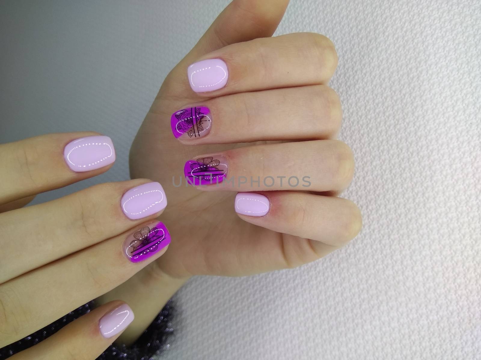 stylish design of manicure on long beautiful nails by SmirMaxStock