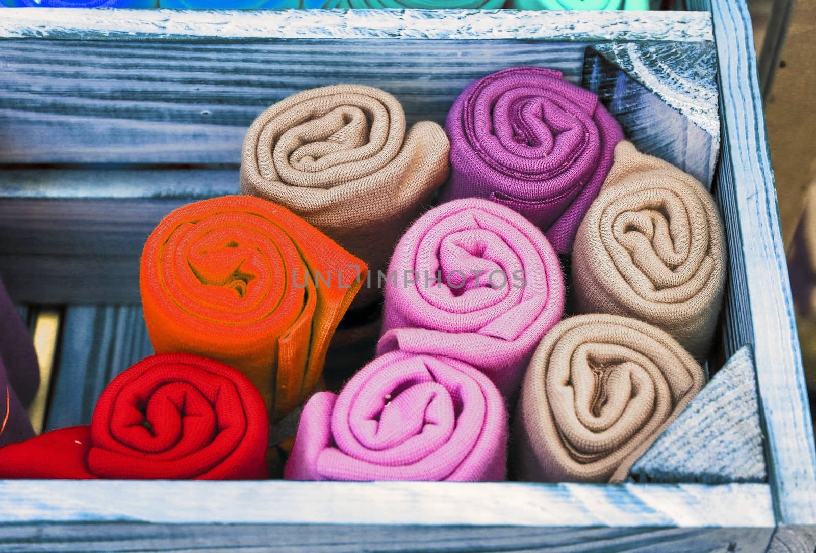 Detailed close up view on samples of cloth and fabrics in different colors found at a fabrics market.