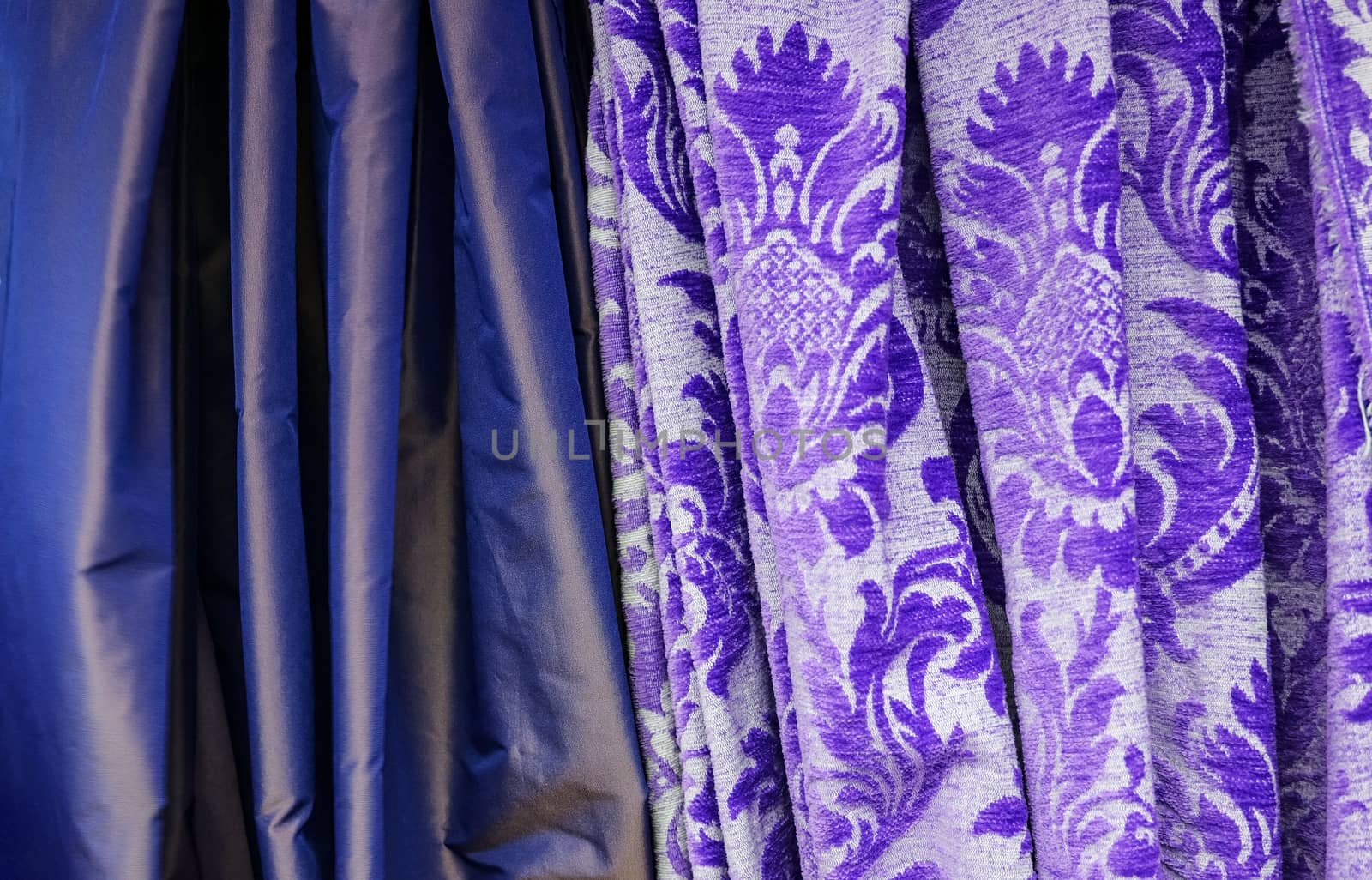 Detailed close up view on samples of cloth and fabrics in different colors found at a fabrics market.