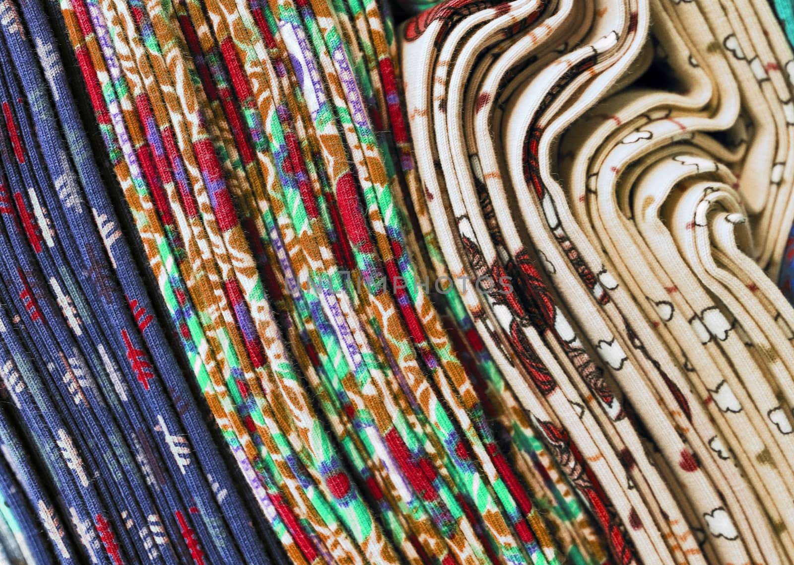 Detailed close up view on samples of cloth and fabrics in different colors found at a fabrics market.