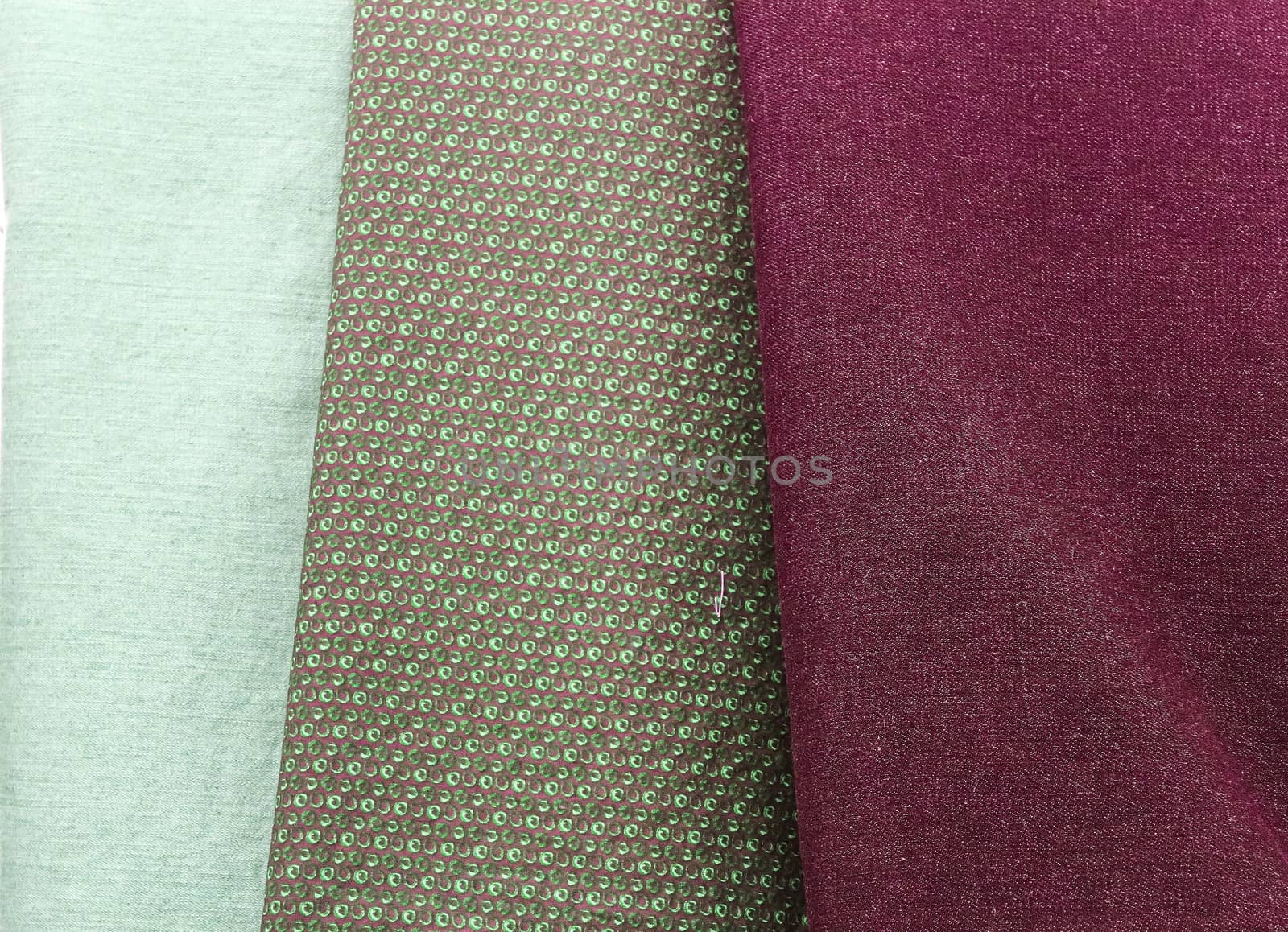 Detailed close up view on samples of cloth and fabrics in different colors found at a fabrics market.