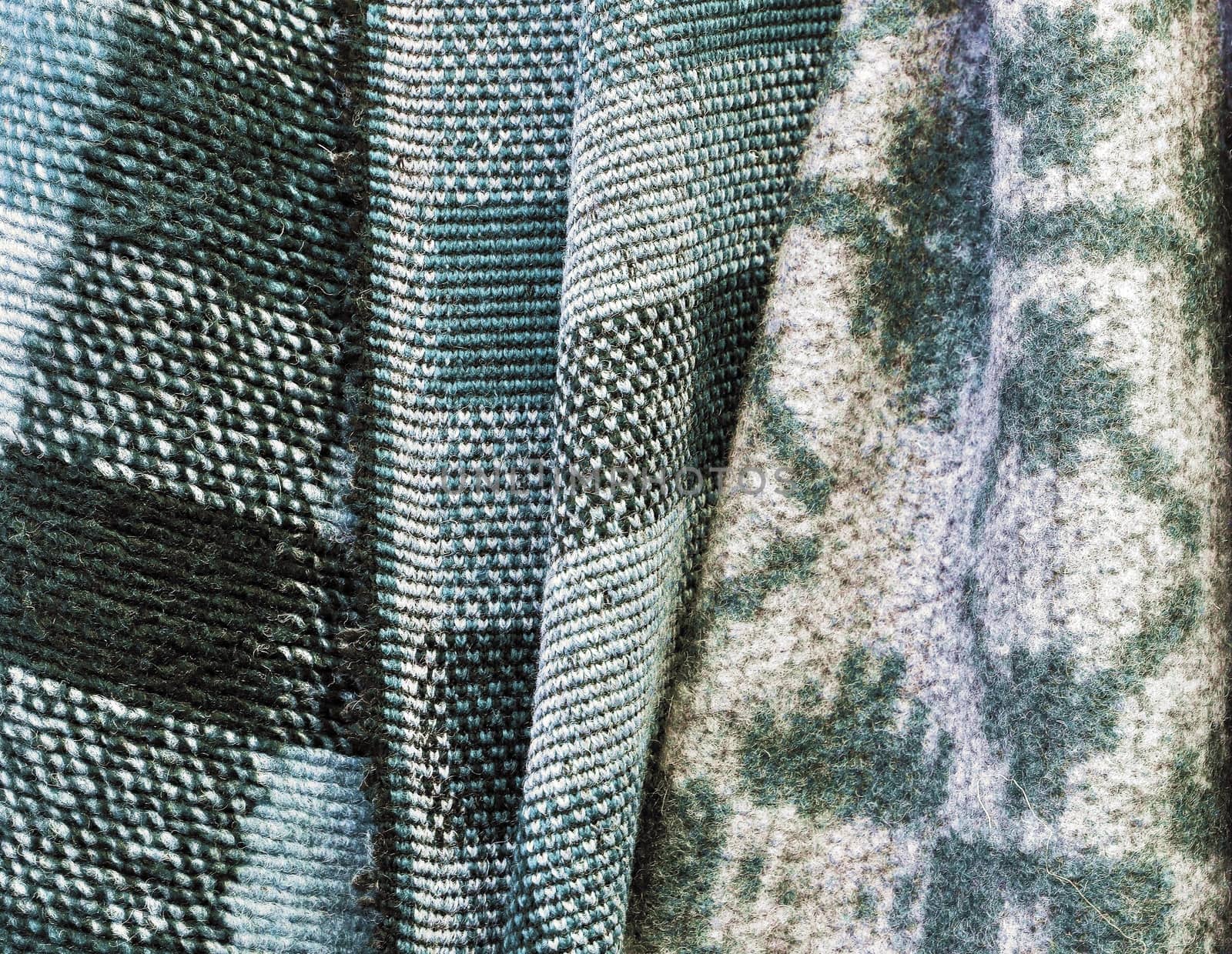 Detailed close up view on samples of cloth and fabrics in different colors found at a fabrics market.