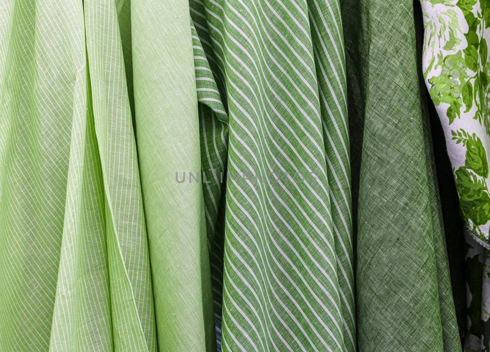 Detailed close up view on samples of cloth and fabrics in different colors found at a fabrics market.