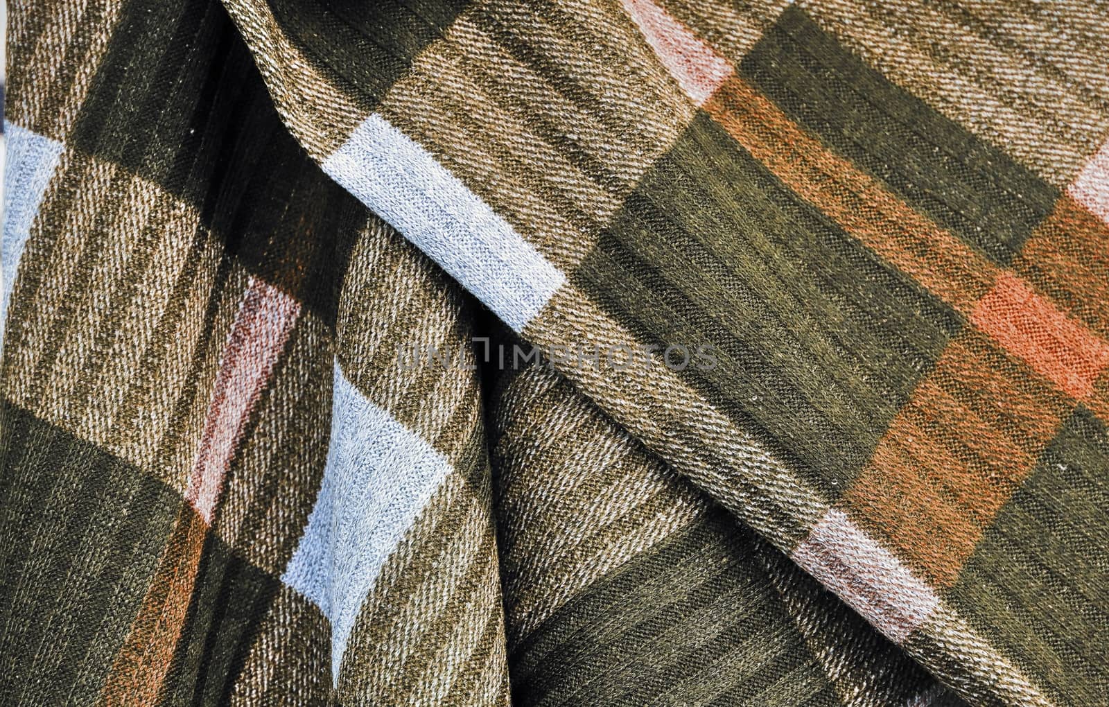 Detailed close up view on samples of cloth and fabrics in different colors found at a fabrics market.