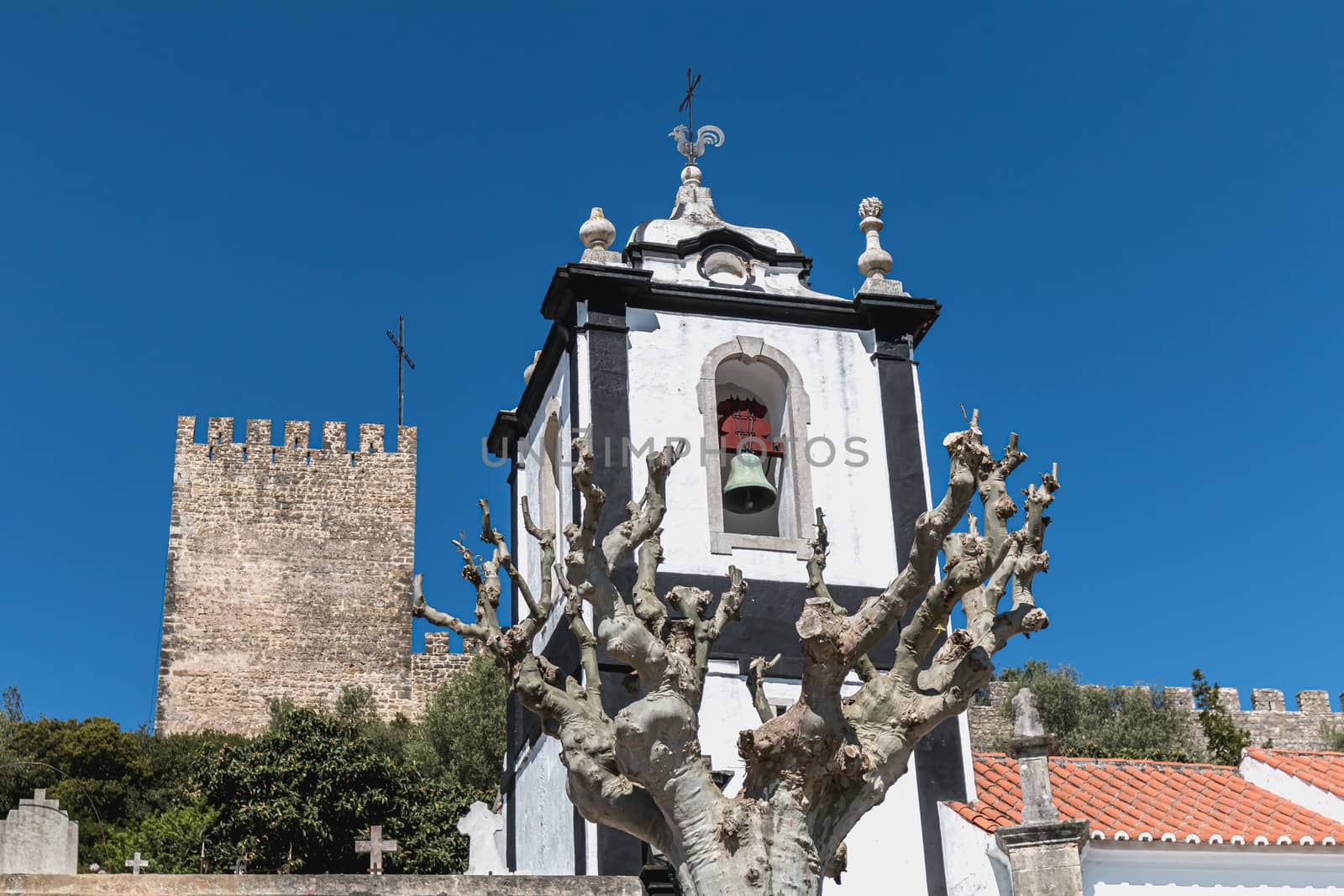 Obidos, Portugal - April 12, 2019: View of the entrance to the historic city with its typical architecture on a spring day