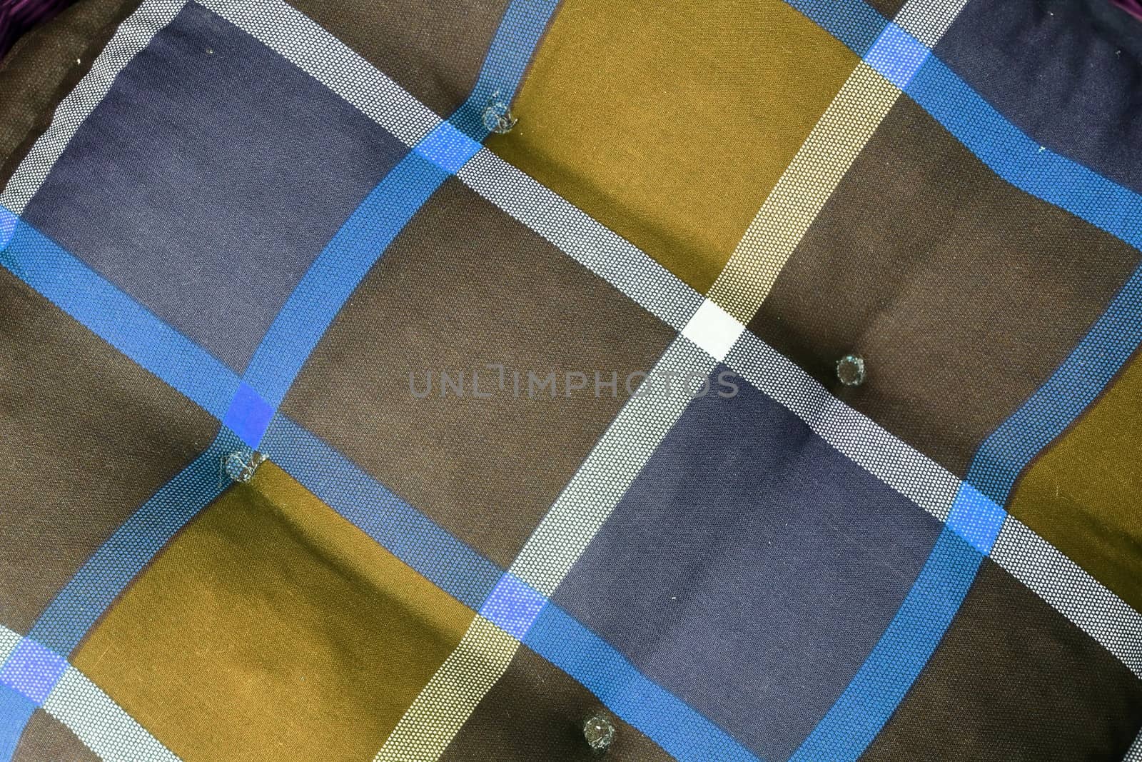 Detailed close up view on samples of cloth and fabrics in different colors found at a fabrics market.