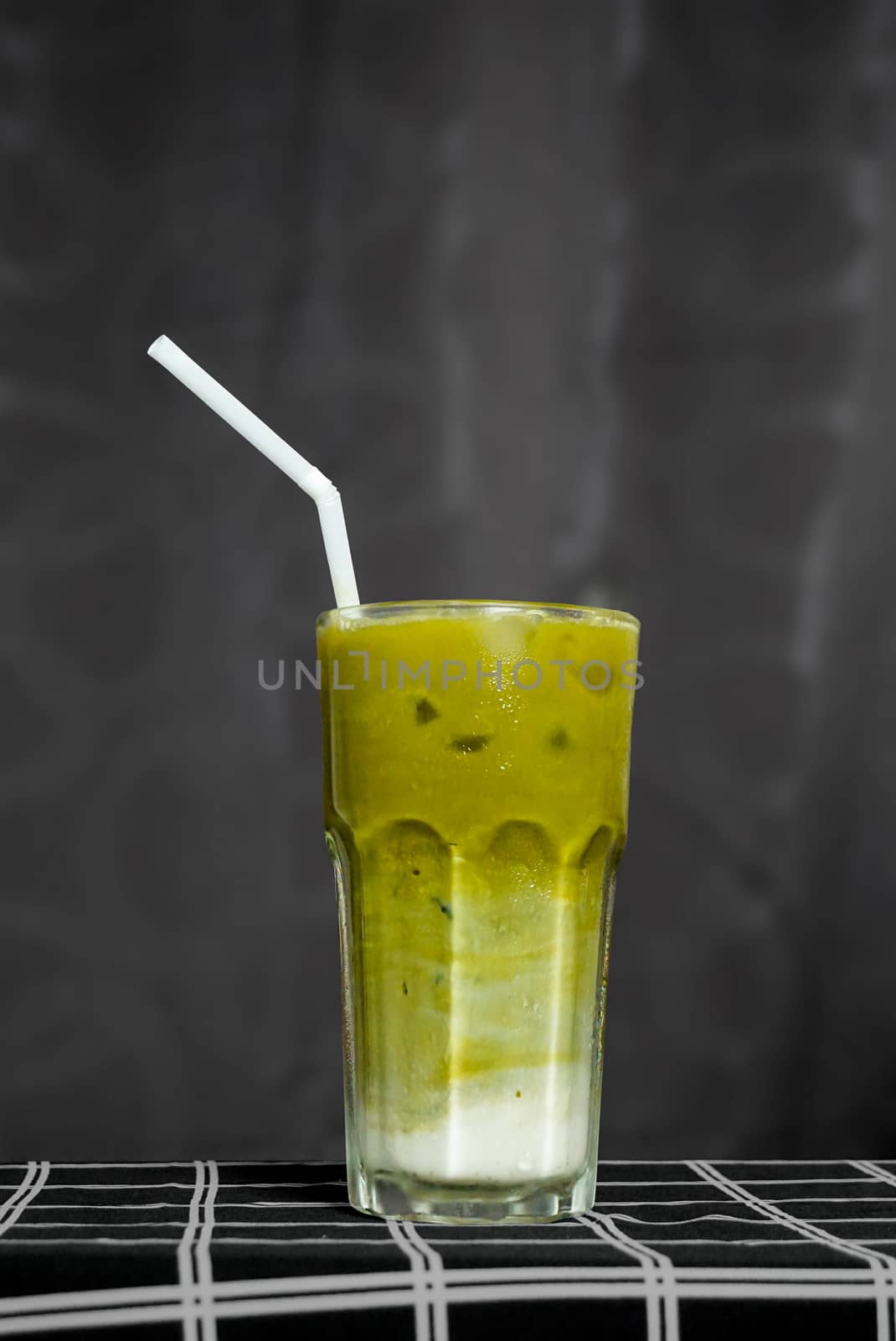 A glass of iced green tea latte.
