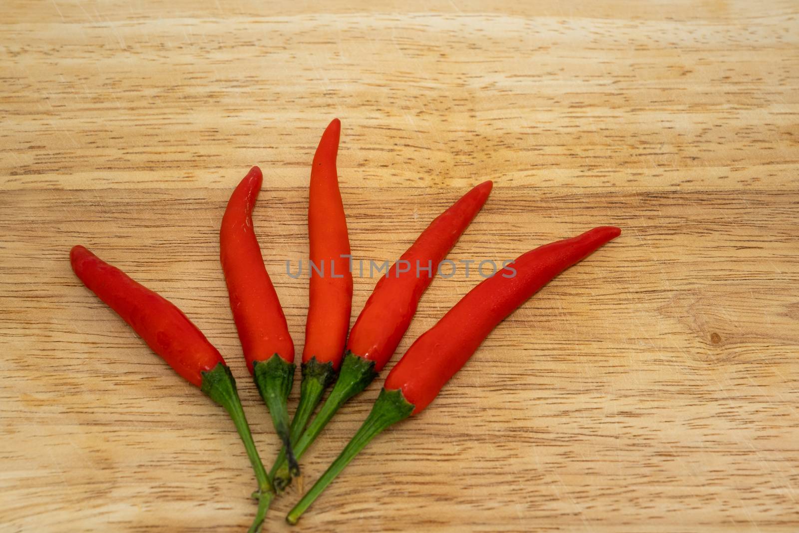 Red Hot Chili Peppers Over Wooden Background by peerapixs