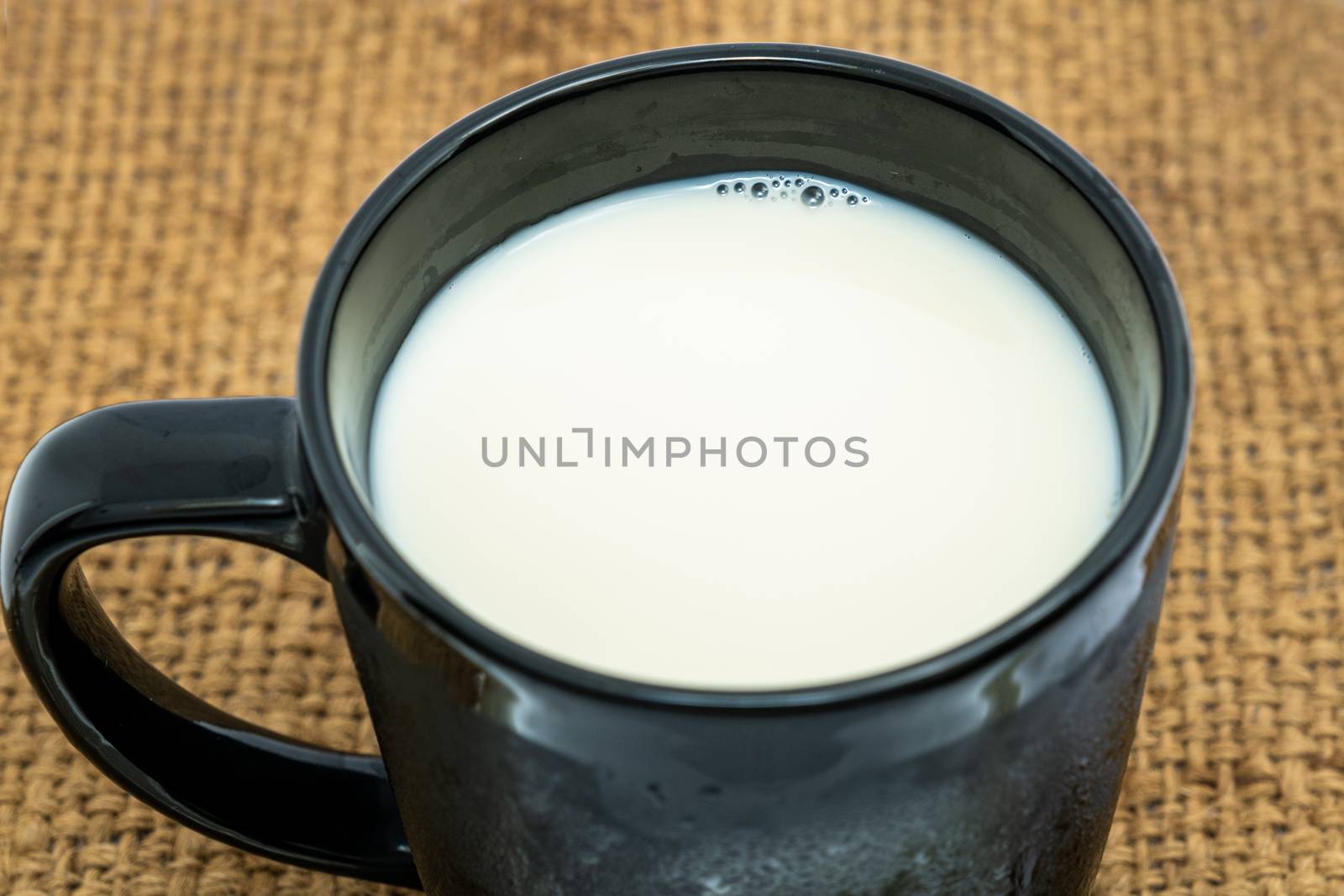 Top view, A black Glass of milk on white background. Healthy beverage concept.