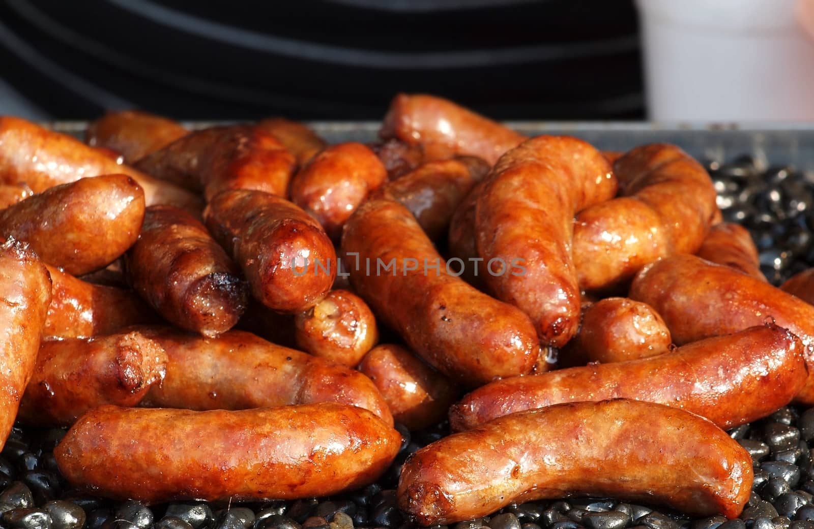 Barbecued sausages are on sale at an outdoor stall
