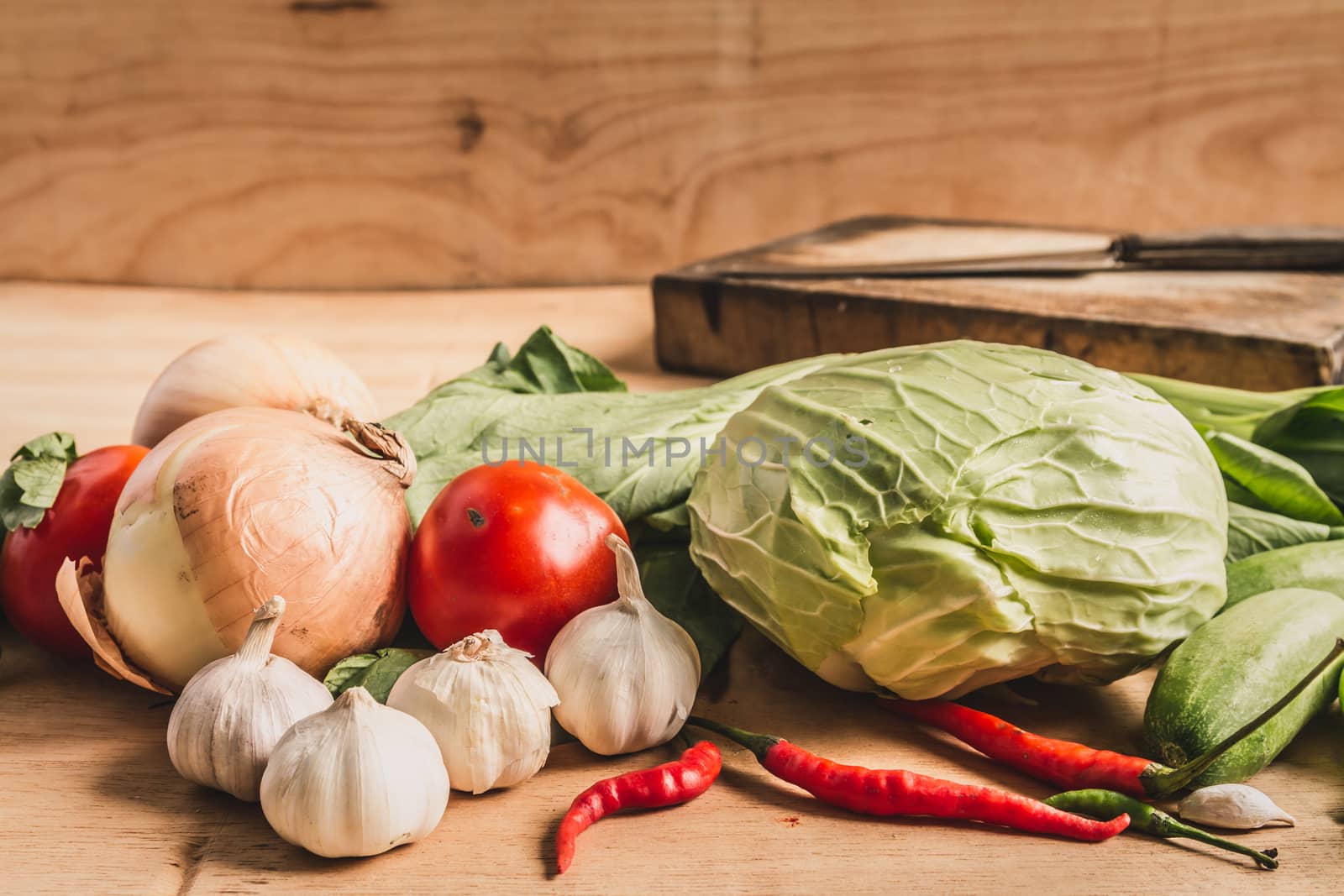 Fresh vegetables on wooden table background.