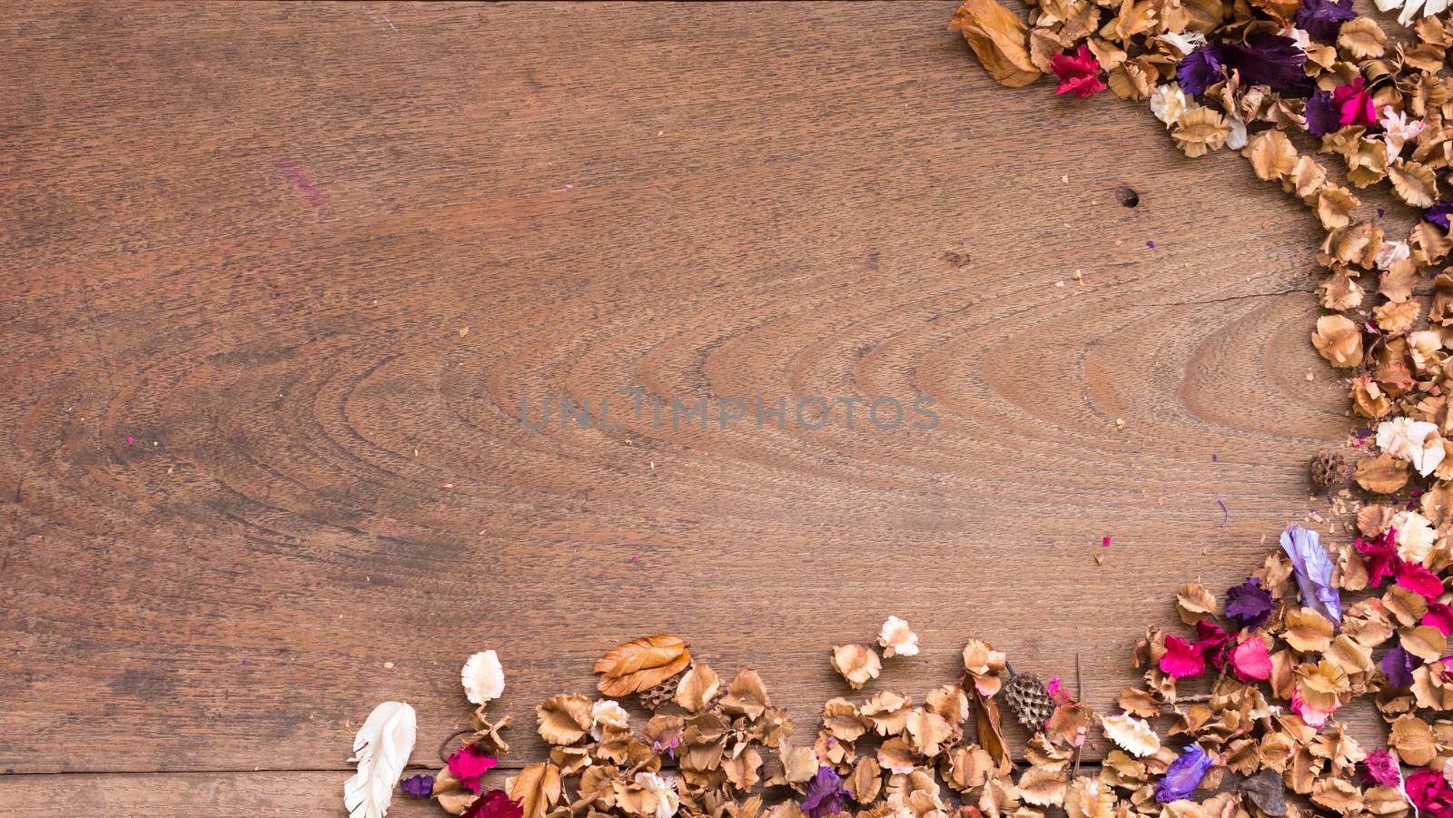 Top view workspace with dried flowers on wooden table background. Free space for text by ronnarong