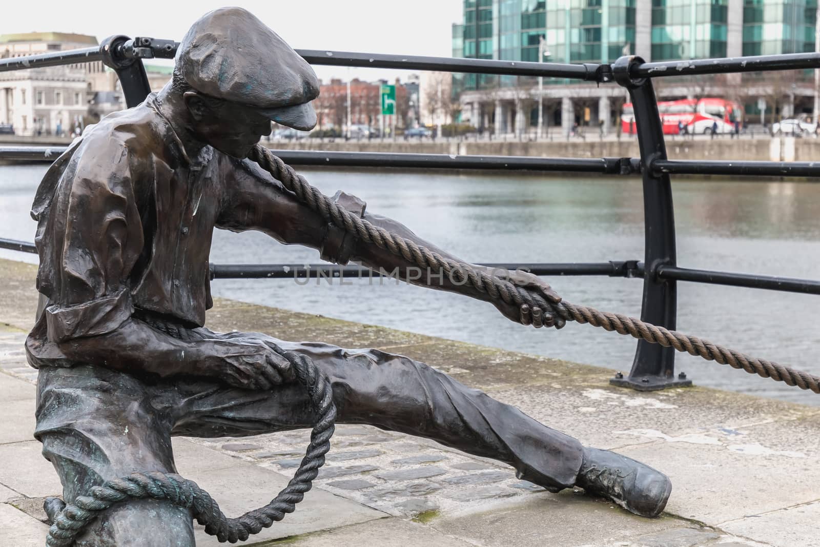 Dublin, Ireland - February 11, 2019: Statue by Dony MacManus of The Linesman on city quay on a winter day