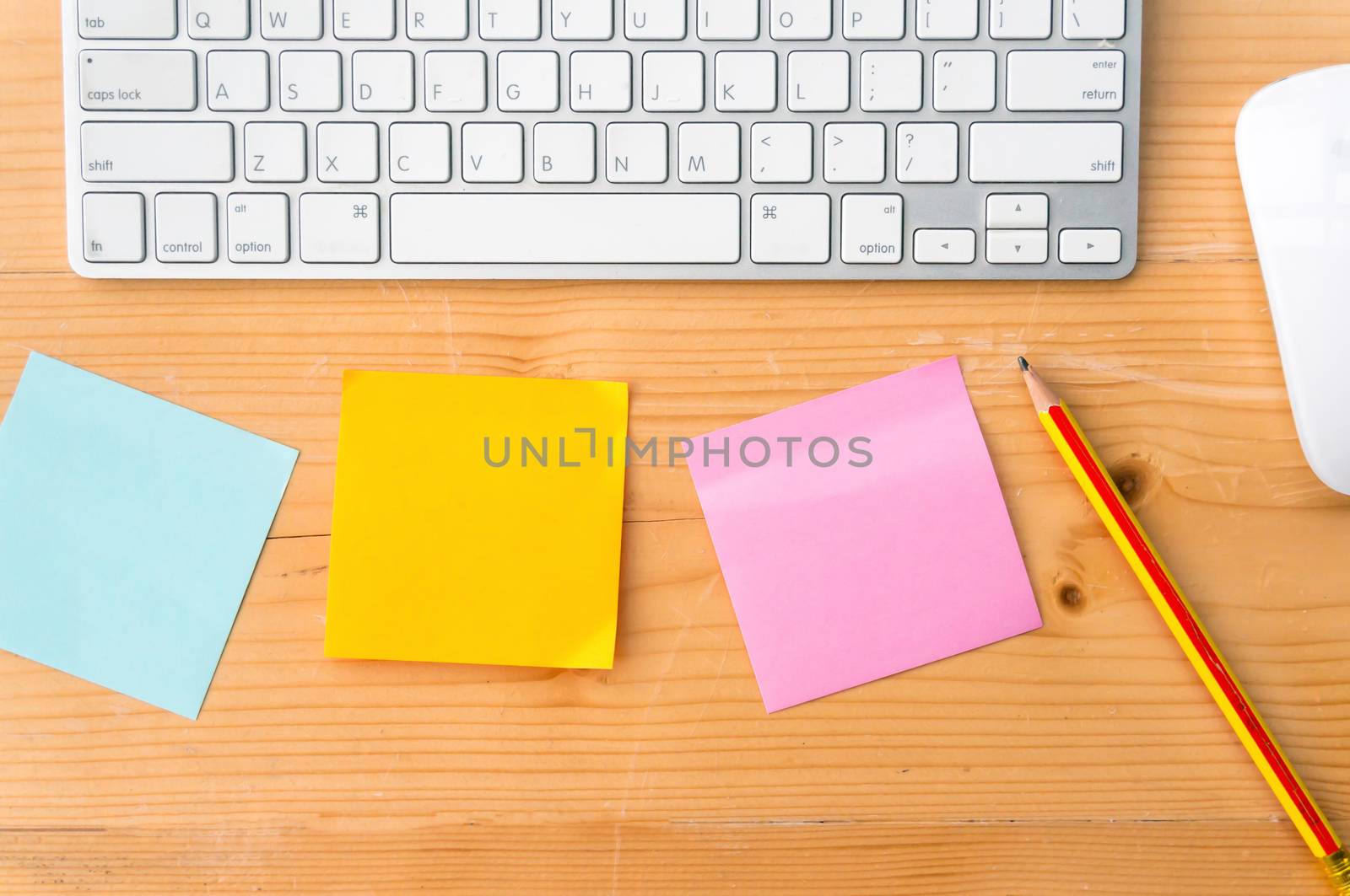 Top view workspace with colorful sticky notes ,pencil, keyboard and mouse on wooden table background. by ronnarong