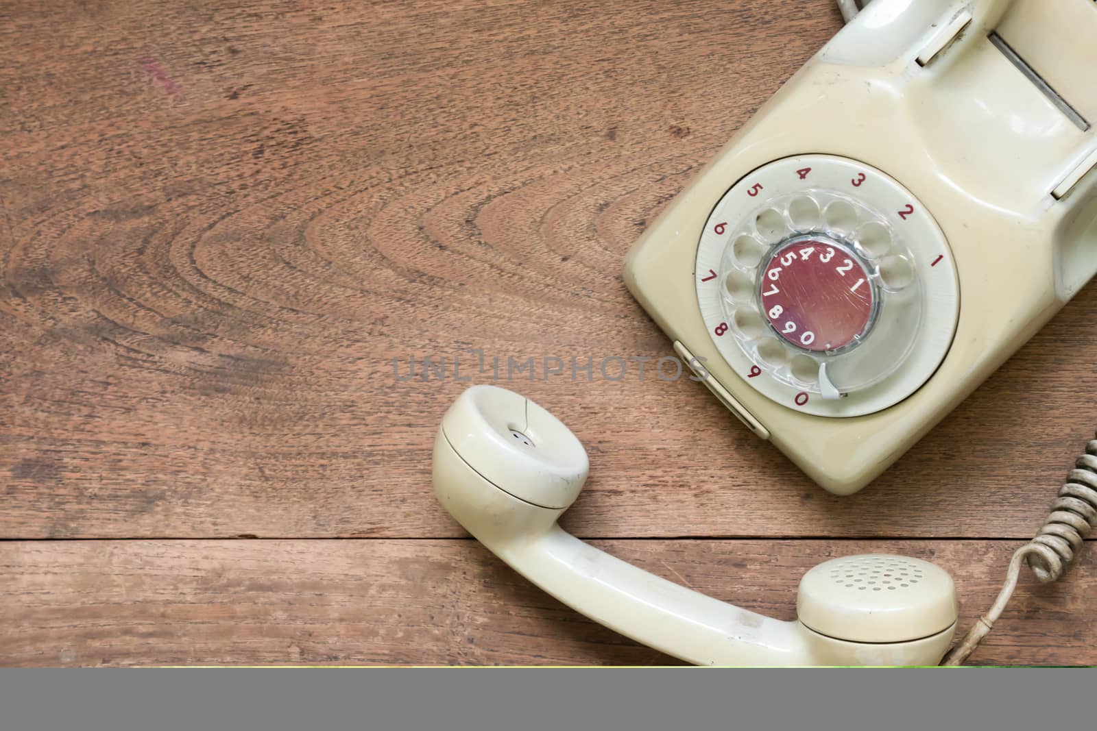 vintage telephone on wooden table background.