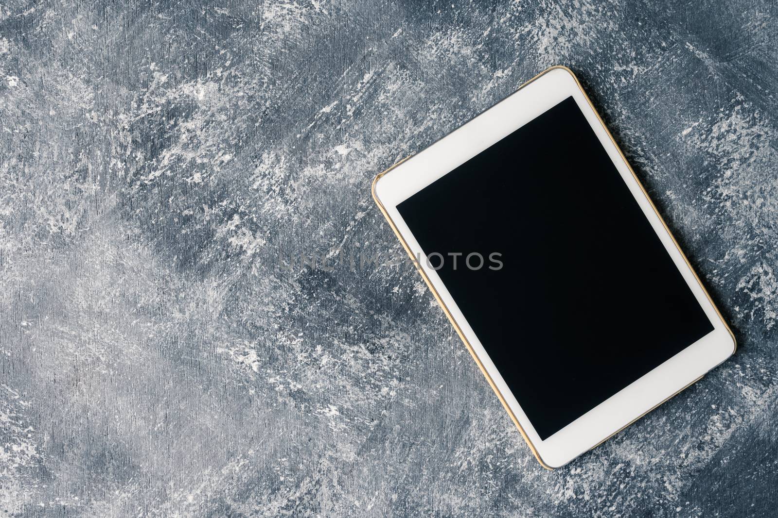 White tablet touch computer gadget with touch blank black screen on grunge background.
