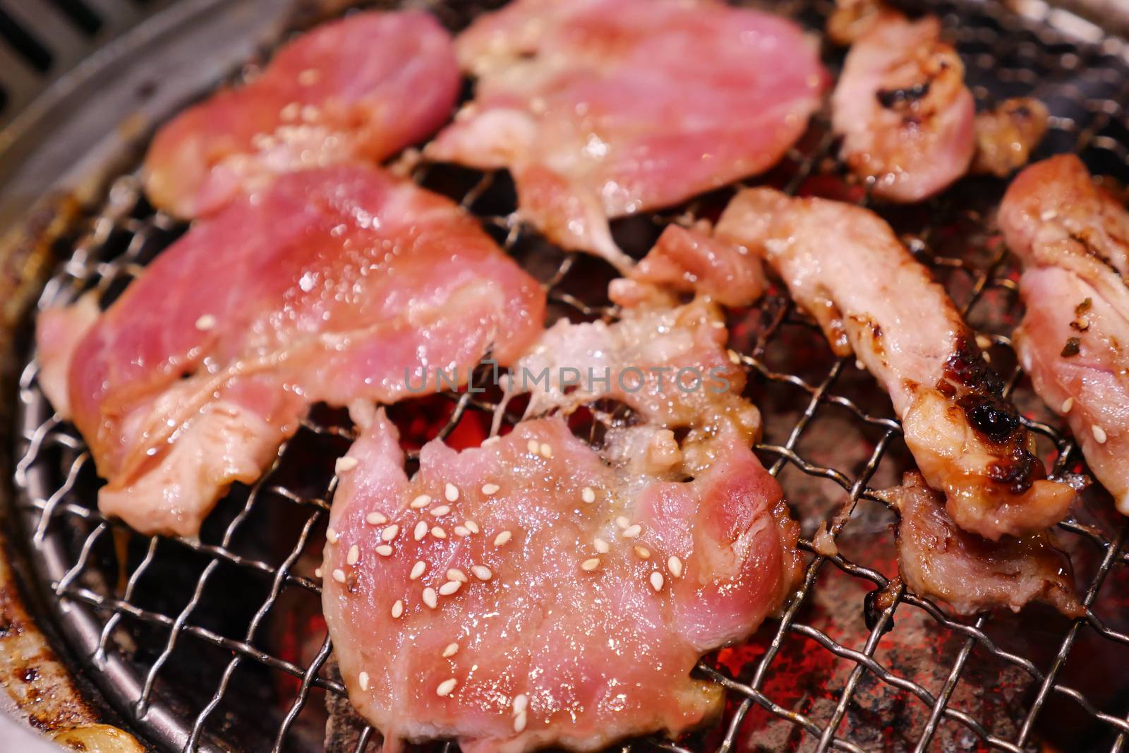 Pork grill on hot coals. This kind of food is a Korean or Japanese BBQ style.