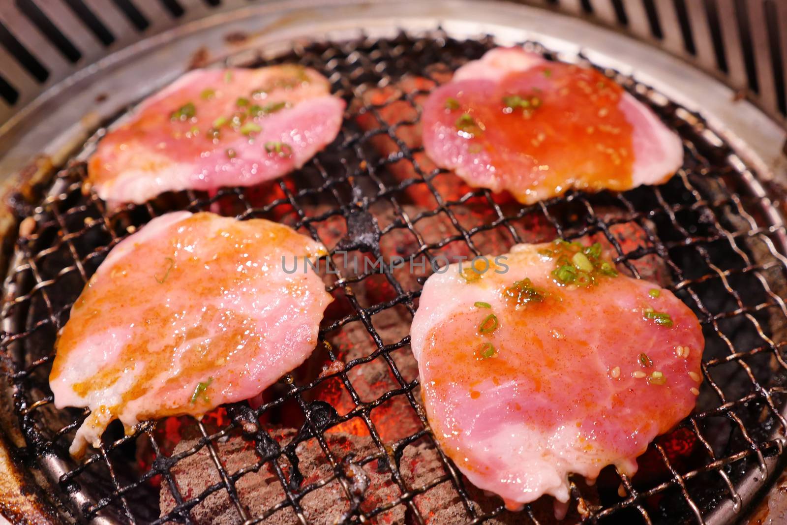 Pork grill on hot coals. This kind of food is a Korean or Japanese BBQ style. by ronnarong