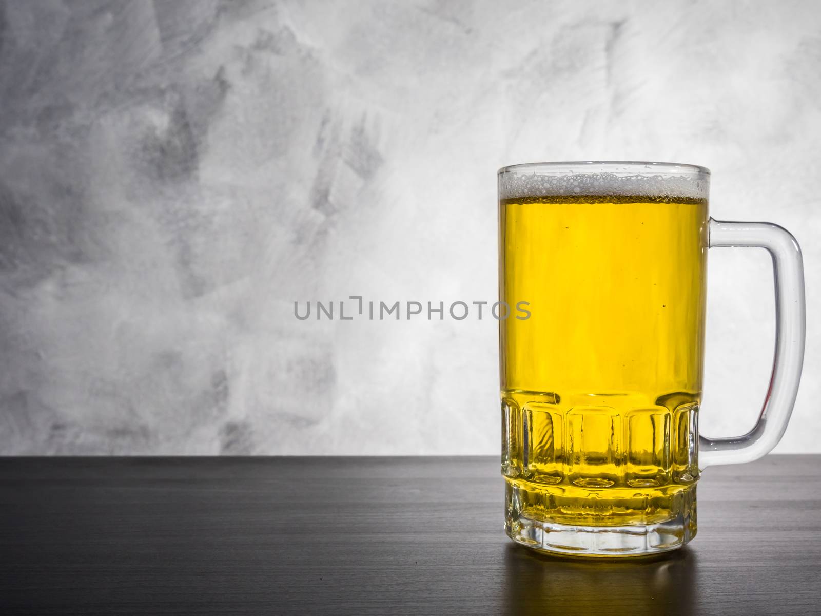 Glass of beer on a grunge background. by ronnarong