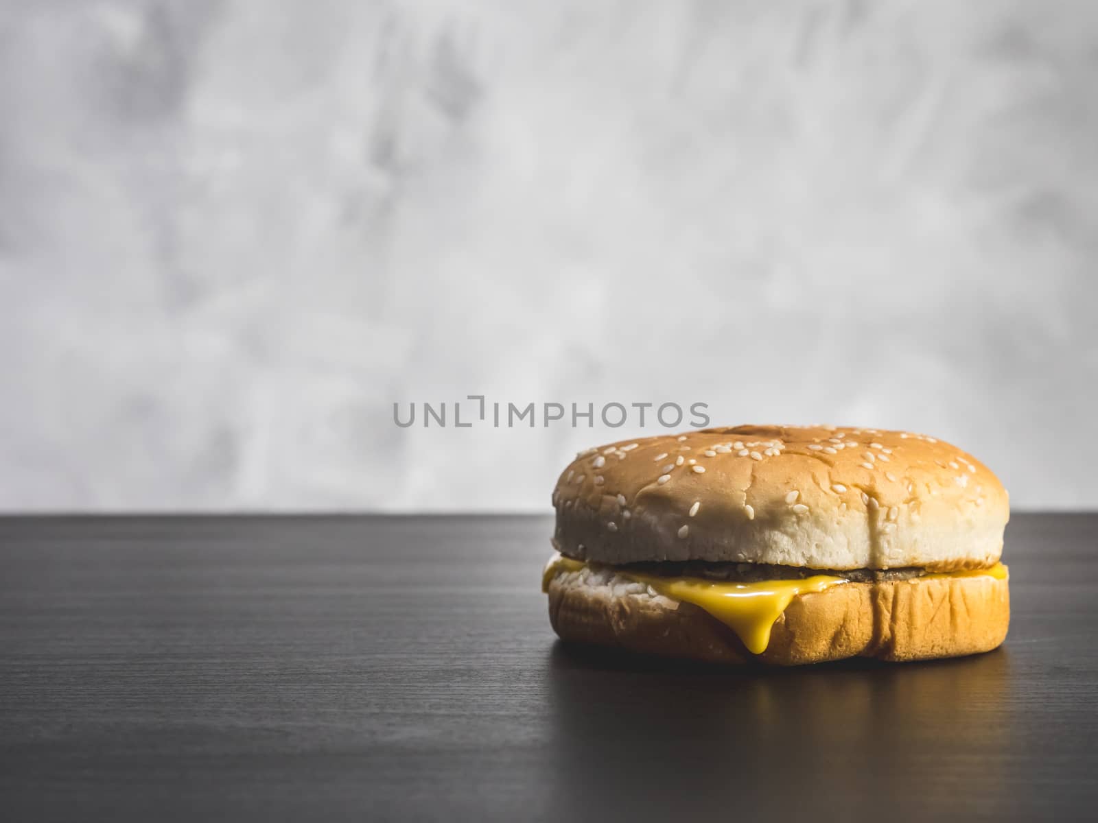 Hamburger  on the table over a grunge background. by ronnarong