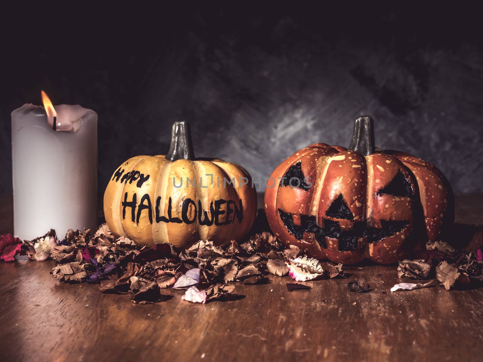 Halloween pumpkins with candlelight on dark background.