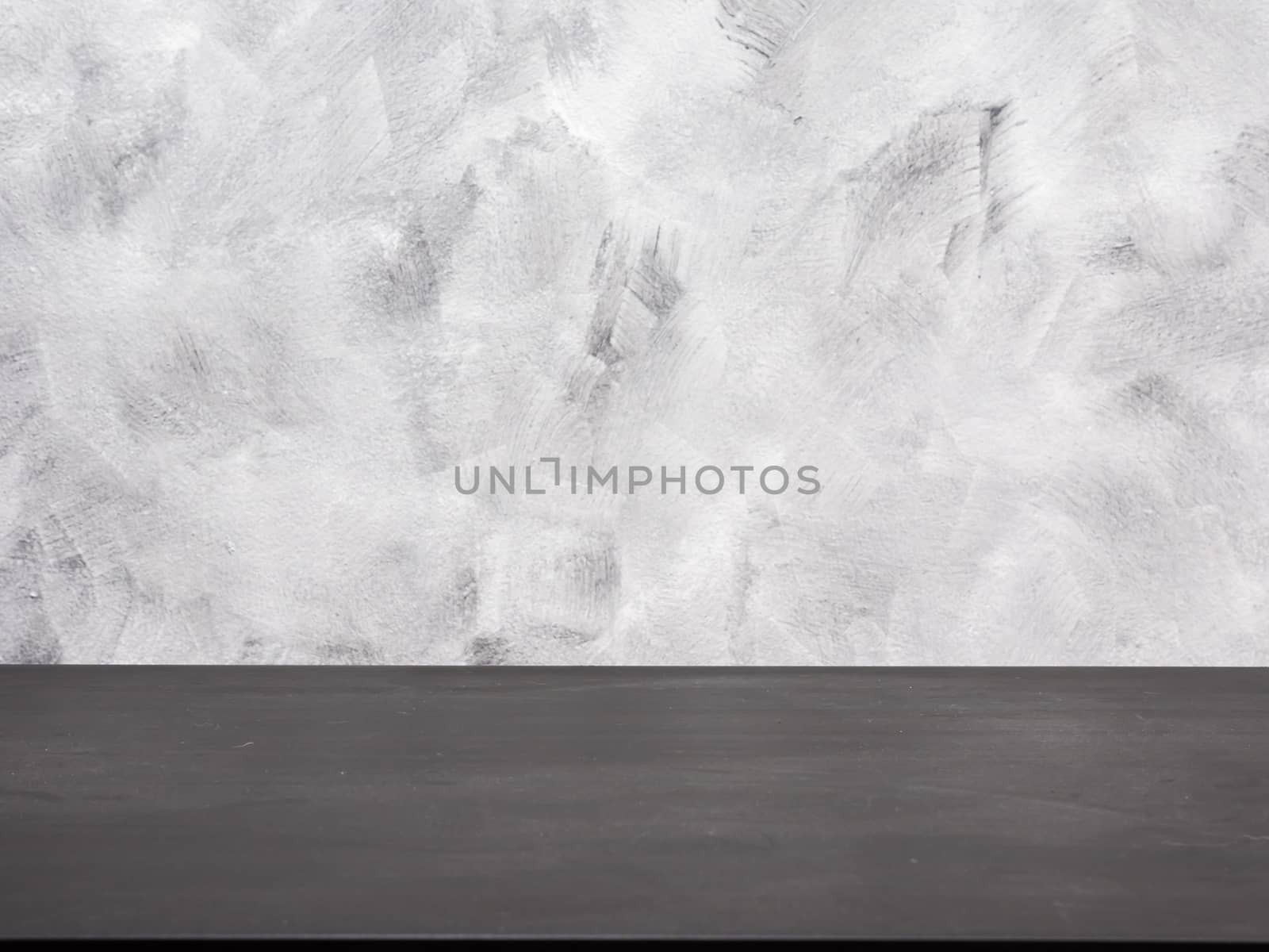Empty black wooden table on a grunge background.