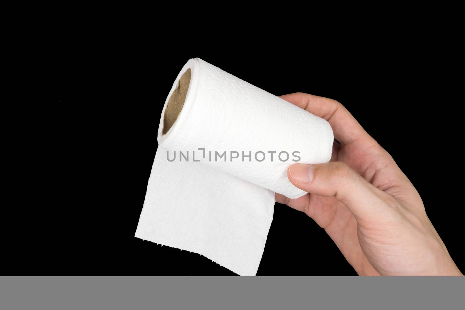 Toilet paper roll with hand on black background. by ronnarong