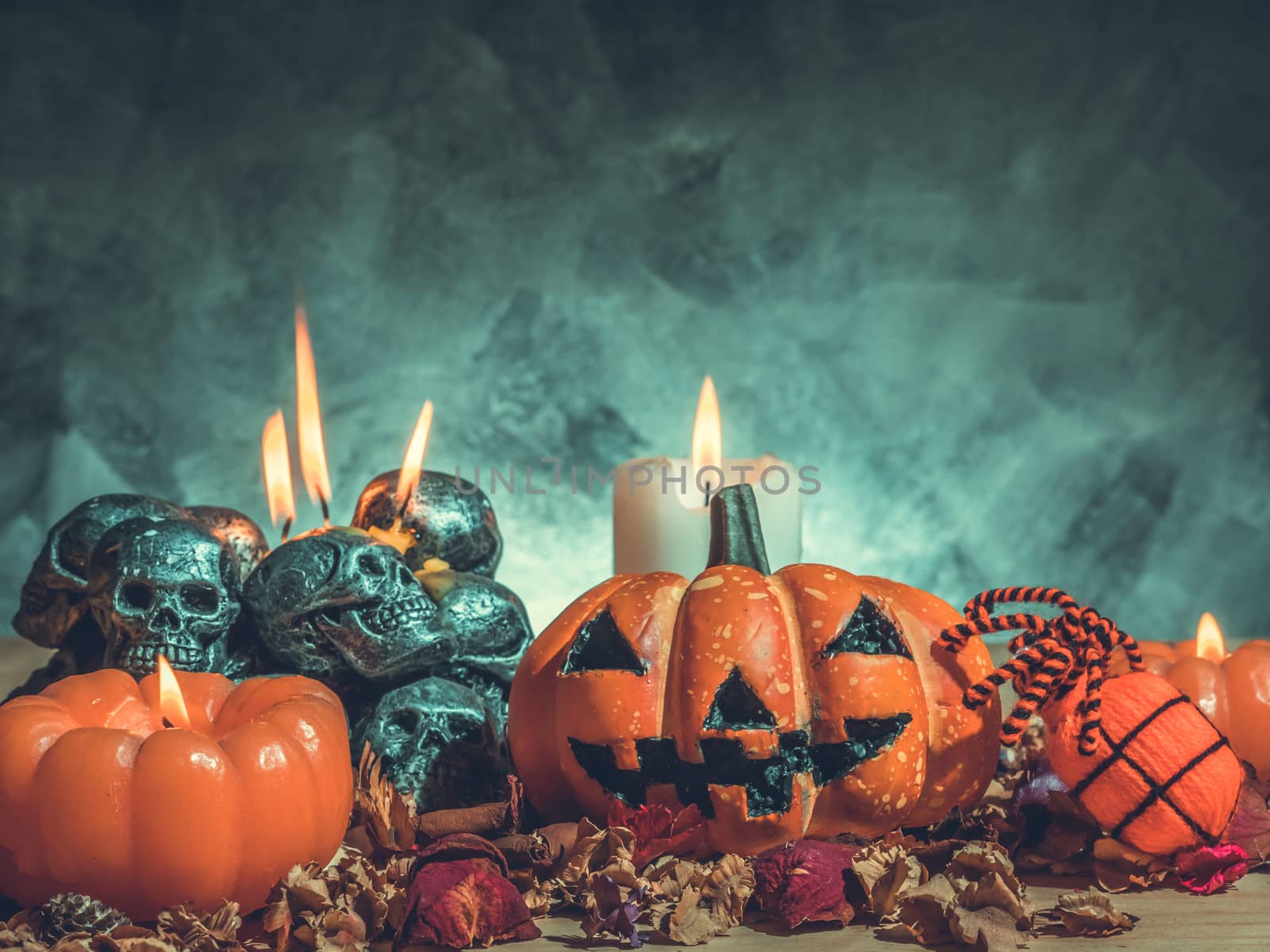Halloween pumpkins with candlelight and skulls on dark background. Vintage tone by ronnarong