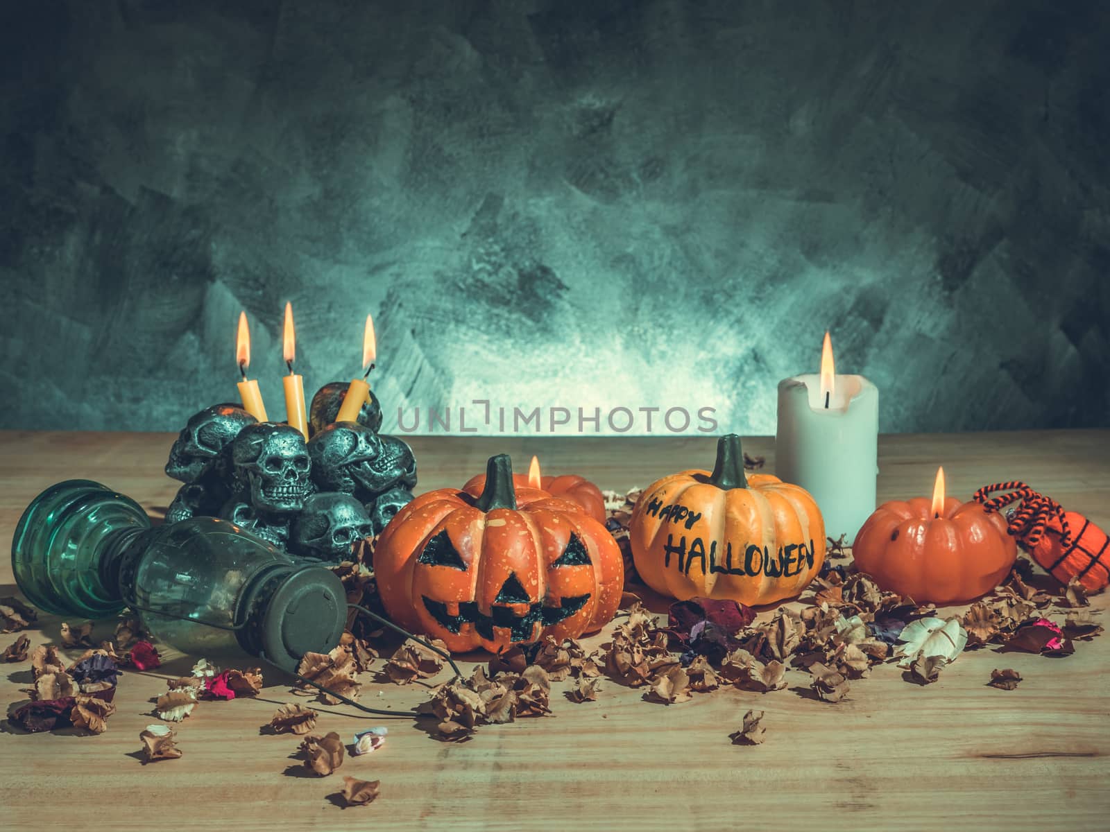 Halloween pumpkins with candlelight and skulls on dark background. Vintage tone by ronnarong