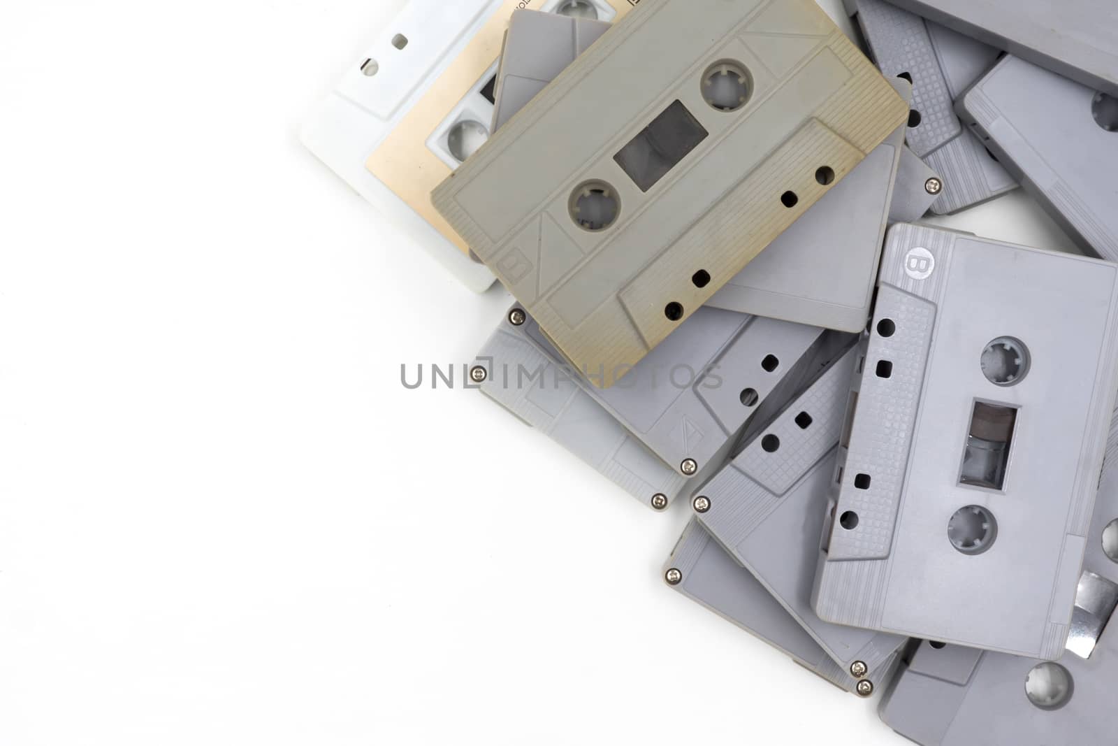 group of old cassette tapes on white background. by ronnarong