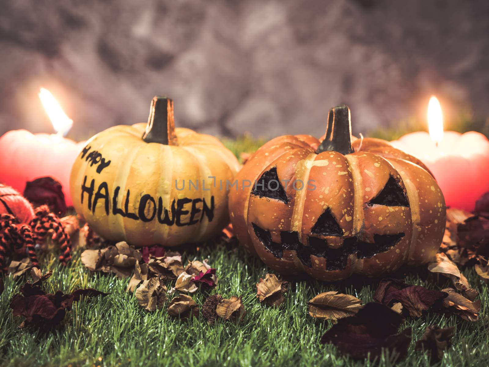 Halloween pumpkins with candlelight on dark background.